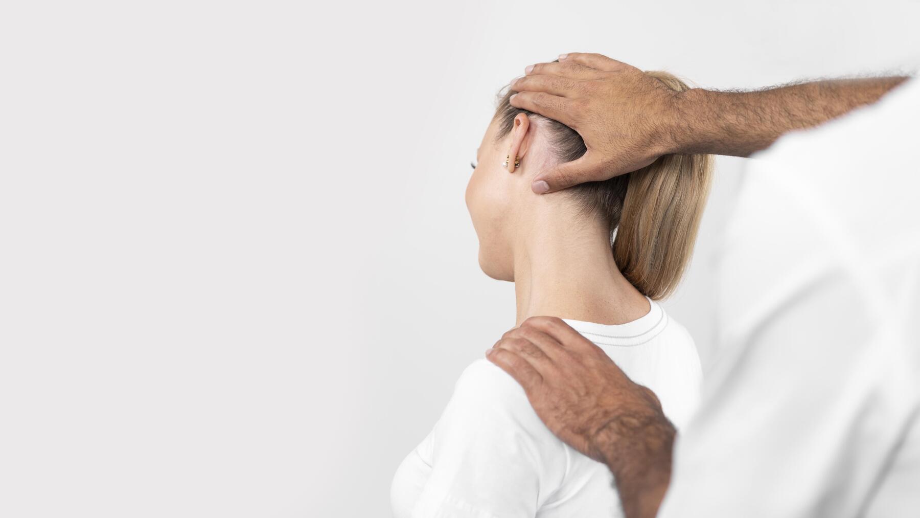 male-physiotherapist-checking-woman-s-neck-pain